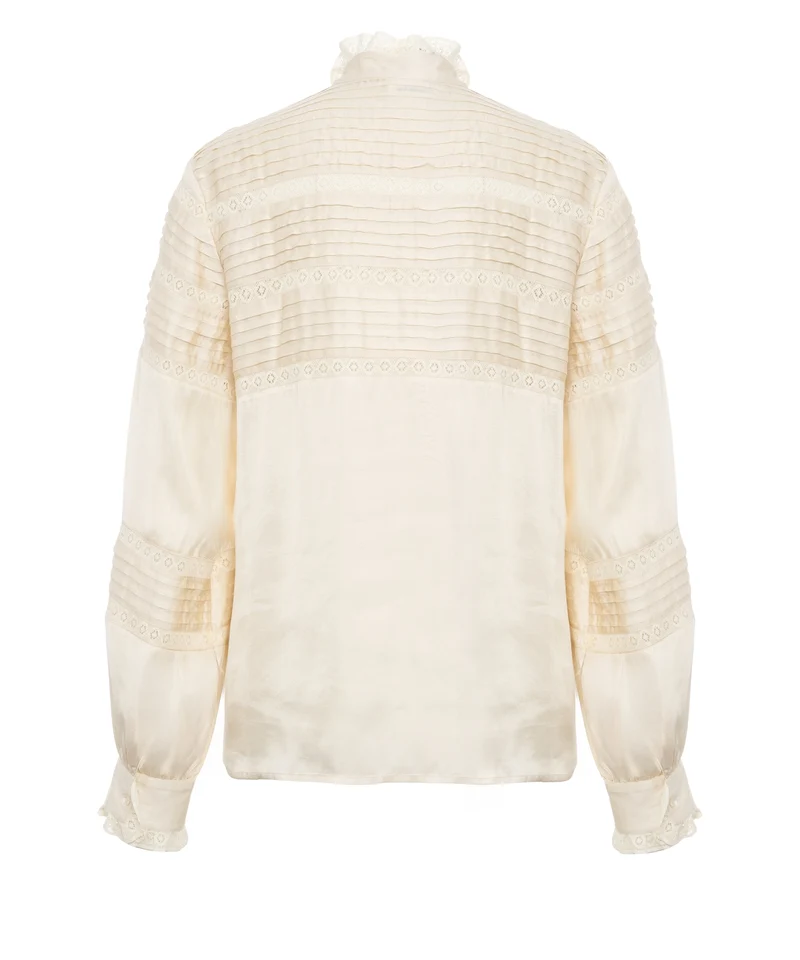 Blusa con dettagli con volant